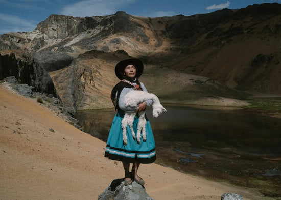 Alina Surquislla Gomez holding a baby alpaca - Photographer Alessandro Cinque