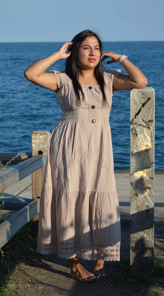 Woman wearing beige cotton dress at chicago lake front.