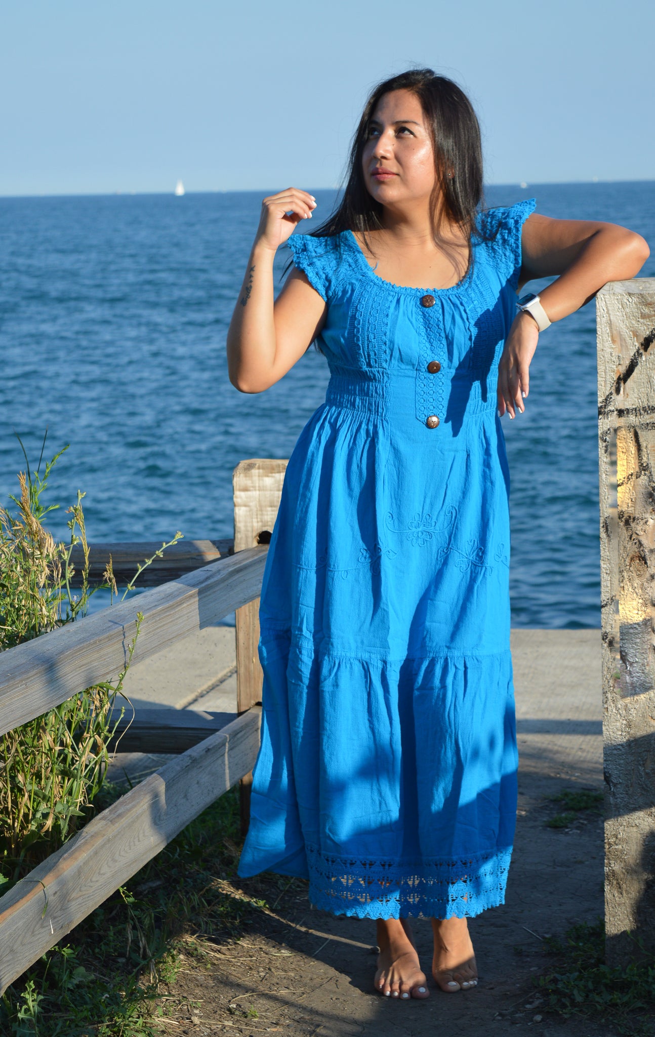 Woman wearing blue cotton dresss at chicago lake front. Sunny