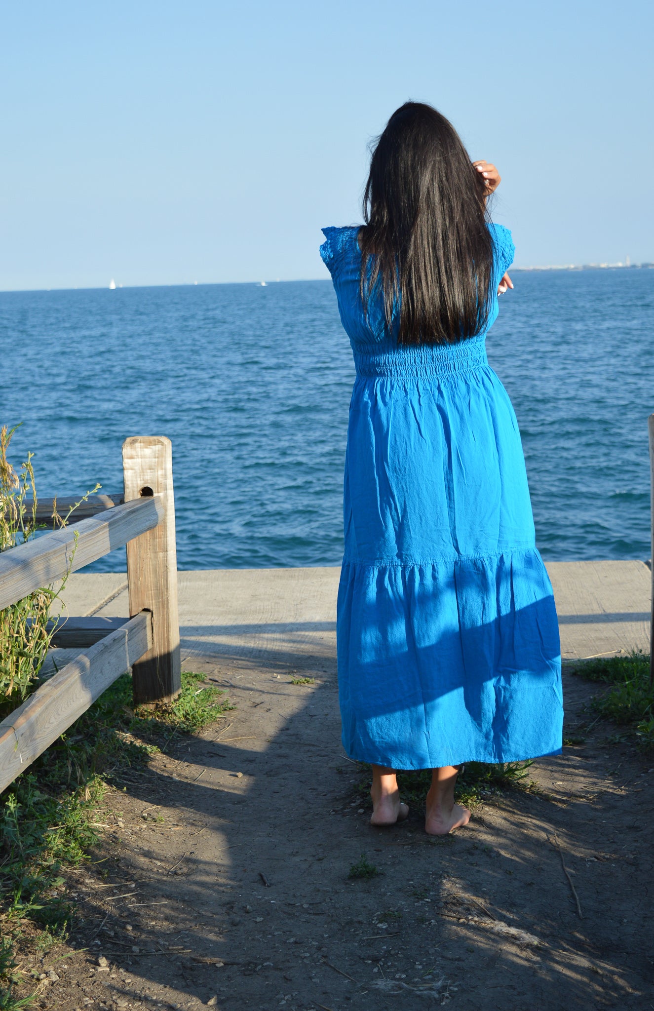 Woman wearing blue cotton dresss at chicago lake front. Sunny