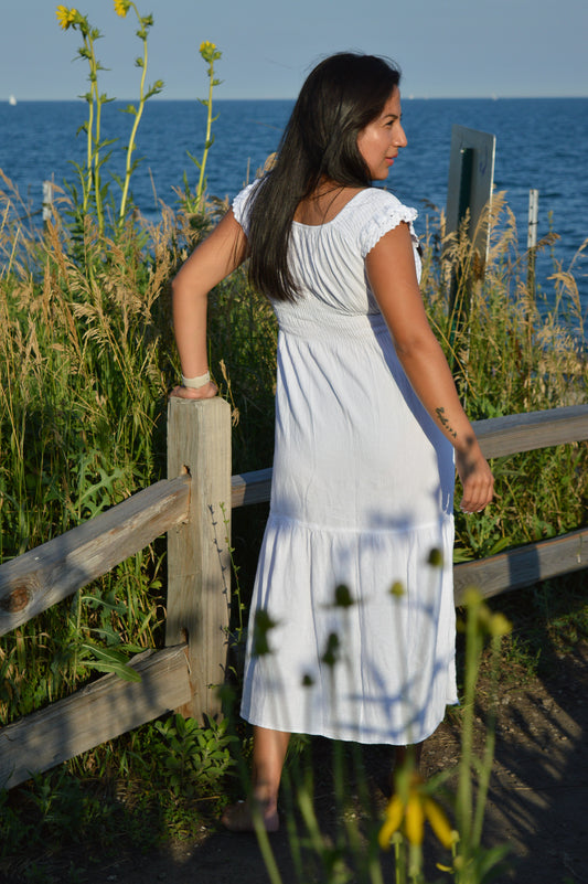 Woman wearing white cotton dresss at chicago lake front. Sunny